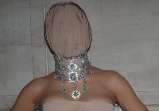kim kardashian sporting a gemstone necklace and mask at the academy museum gala